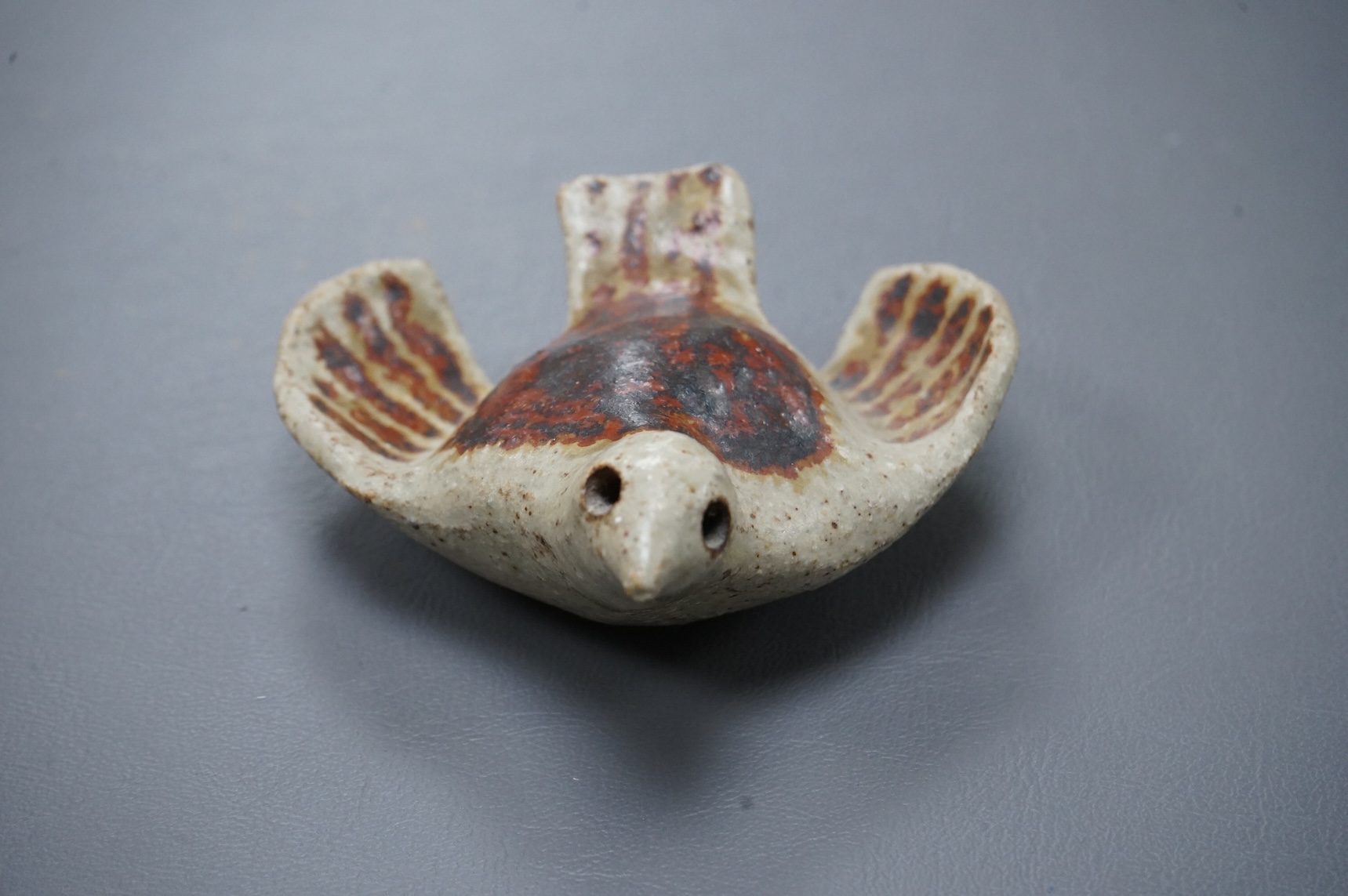 Eric James Mellon (1925 - 2014), a small studio pottery and apple ash-glazed model of a bird, 10cm wide